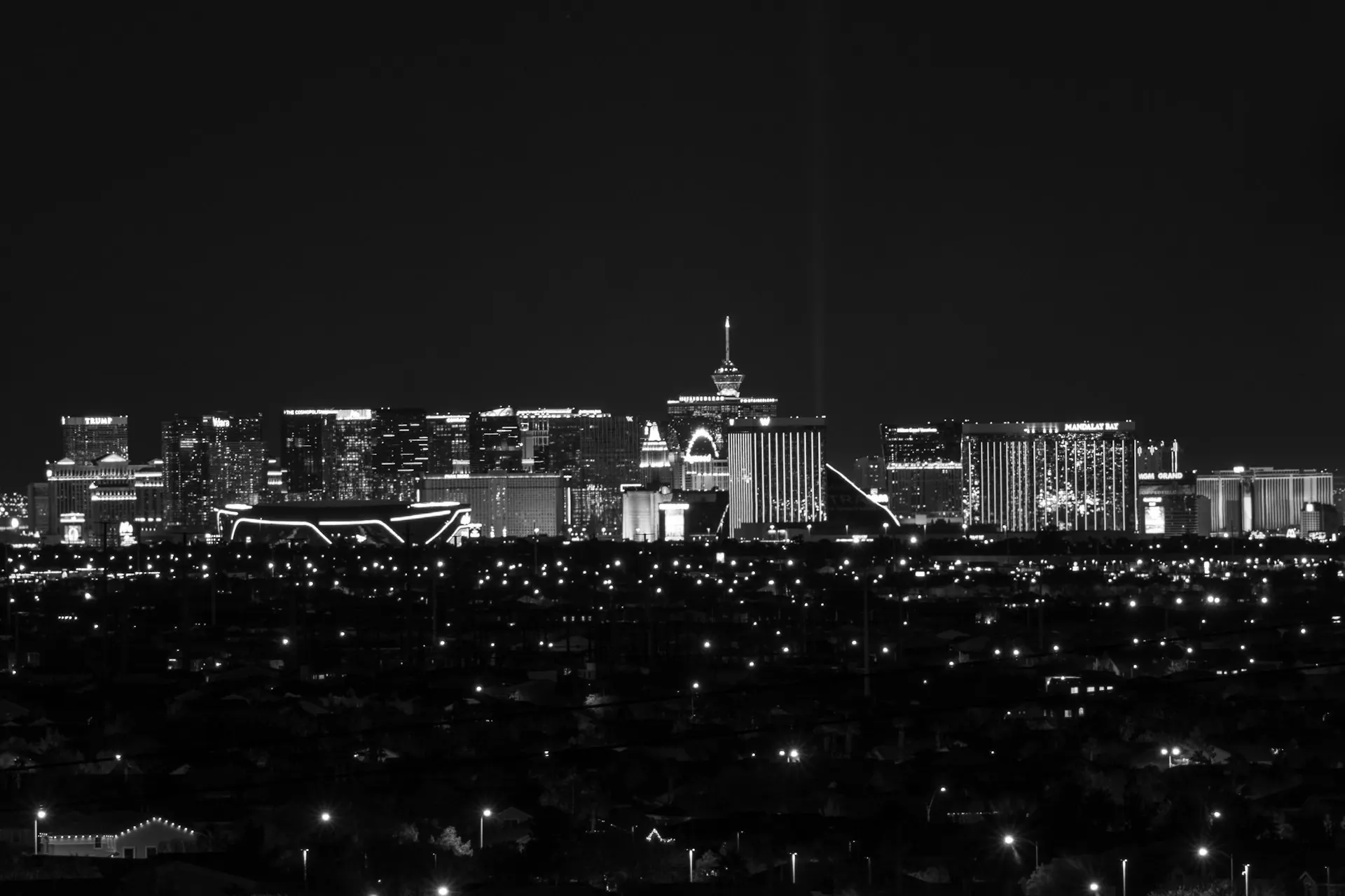 Night view of Las Vegas high-rises popular with midtown condo buyers. Las Vegas Strip illuminated at night with high-rise towers and urban condo skyline